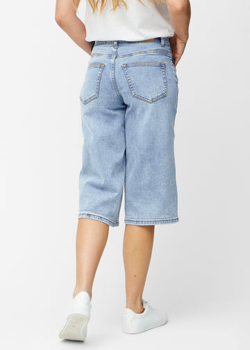 Loose, light blue denim capris in the colour Waves seen from the back, showing fit and length.