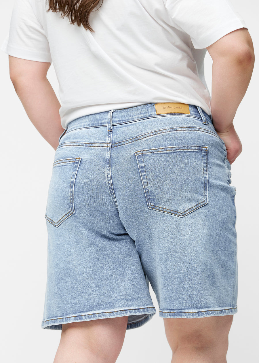 Loose, light blue denim shorts in the colour Waves seen from the back up close on a plus-size model to show fit and details.