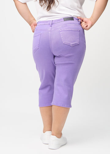 Purple regular capris seen from the back on a plus-size model, so the entire product can be seen.