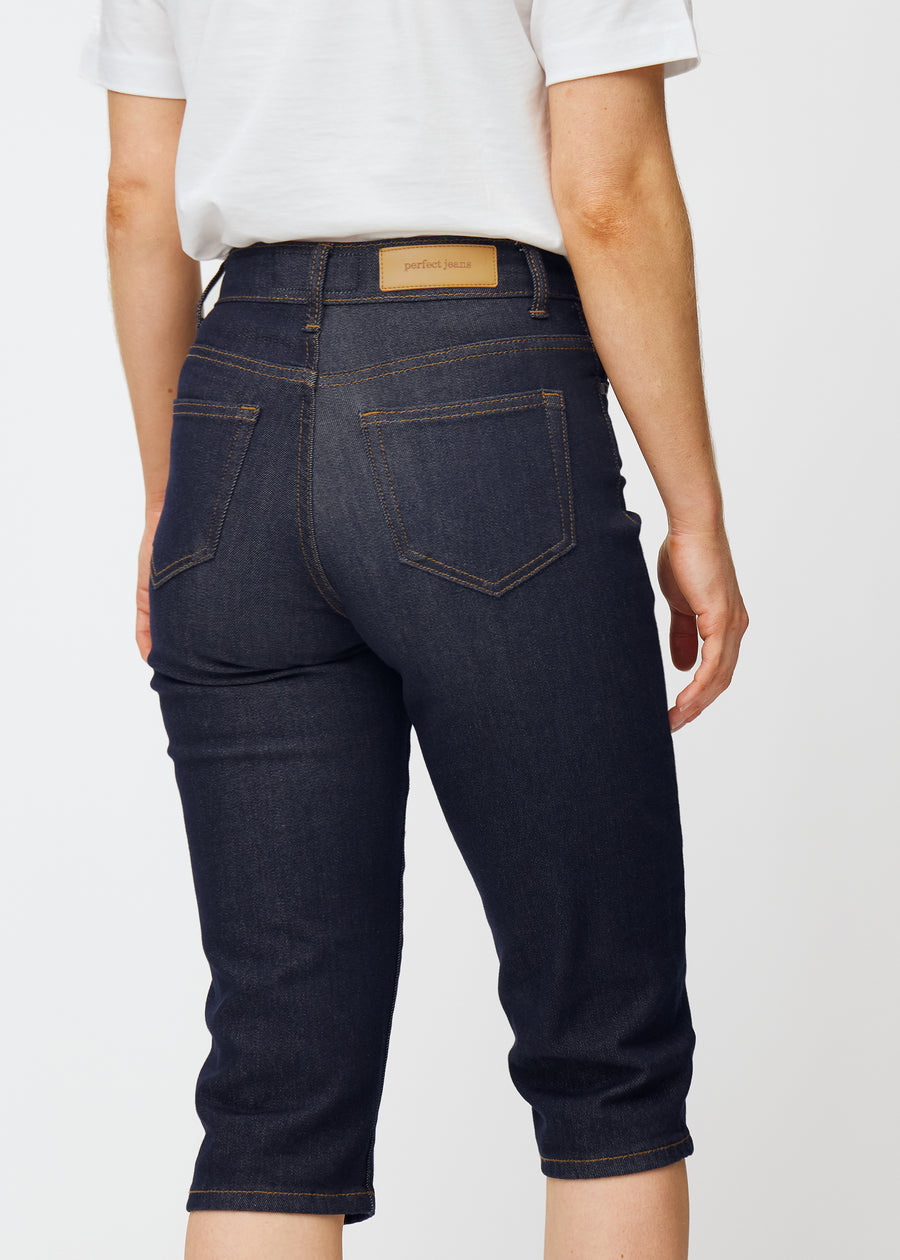 Deep dark blue denim capris for women in the colour Midnights seen from the back in close-up to show fit and details.