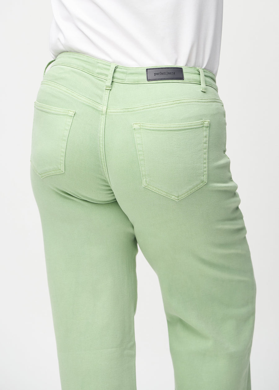 Loose jeans for women in light green, color Mints. Close-up from behind on a plus-size model, showing the fit and details.