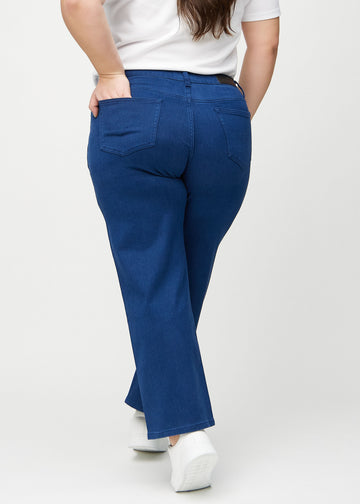 Loose jeans for women in dark blue, color Royals. Back view on a plus-size model, showing the overall relaxed fit.