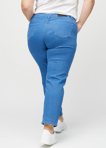 Regular jeans for women in blue, color Geraniums. Back view on a plus-size model, showing the full fit.