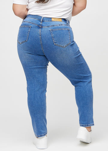 Slim jeans for women in blue, color Rivers. Back view on a plus-size model, showing the overall fit.