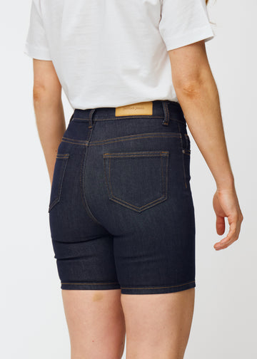 Deep dark blue denim shorts for women in the colour Midnights seen from the back in close-up to show fit and details.