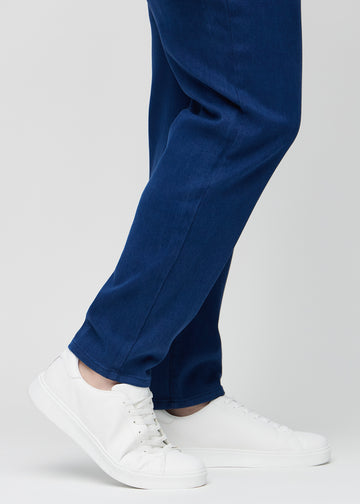 The ankles of a plus-size model, so you can see how loose the jeans fit.