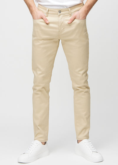 Beige slim jeans, model name Gazelles, fitted closely along the legs , front view.