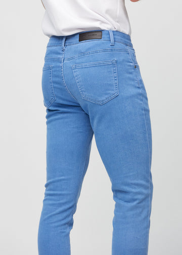 Close-up back view of blue slim jeans showing details.