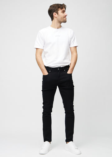 Full-length view of a model in black slim jeans.