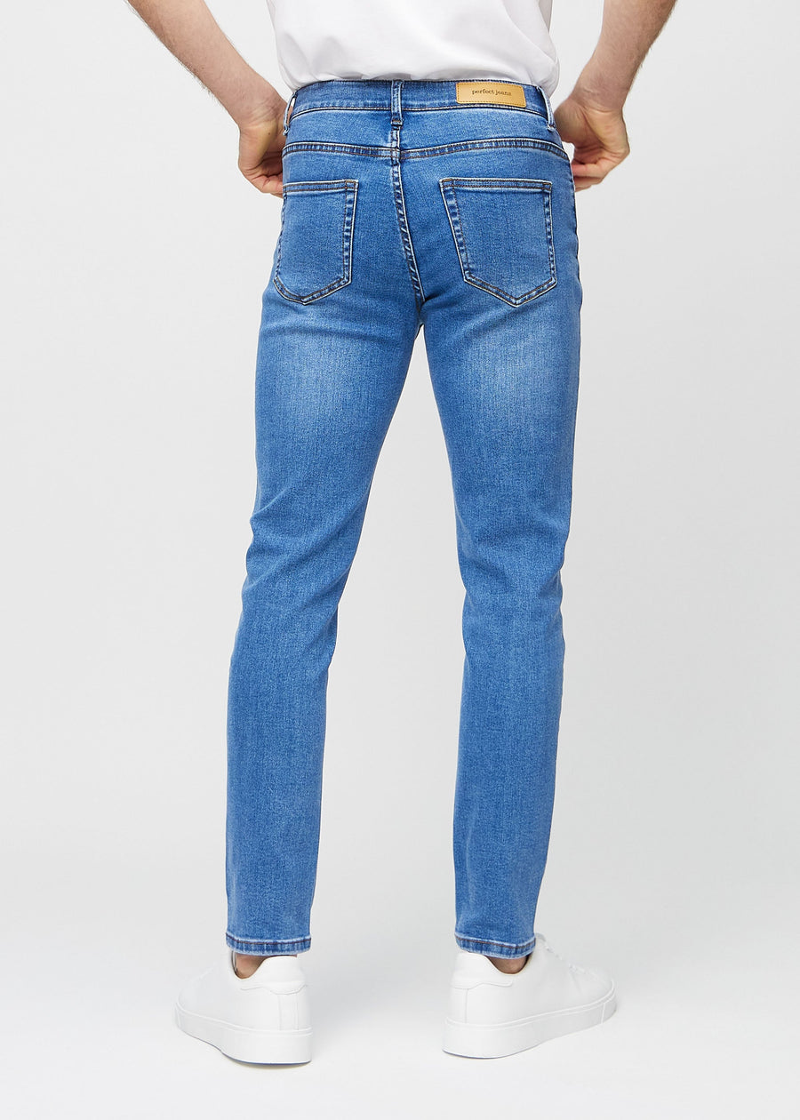 Blue denim slim jeans viewed from the back to show the full product.