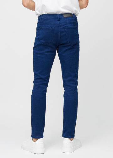 Dark blue slim jeans viewed from the back to show the full product.