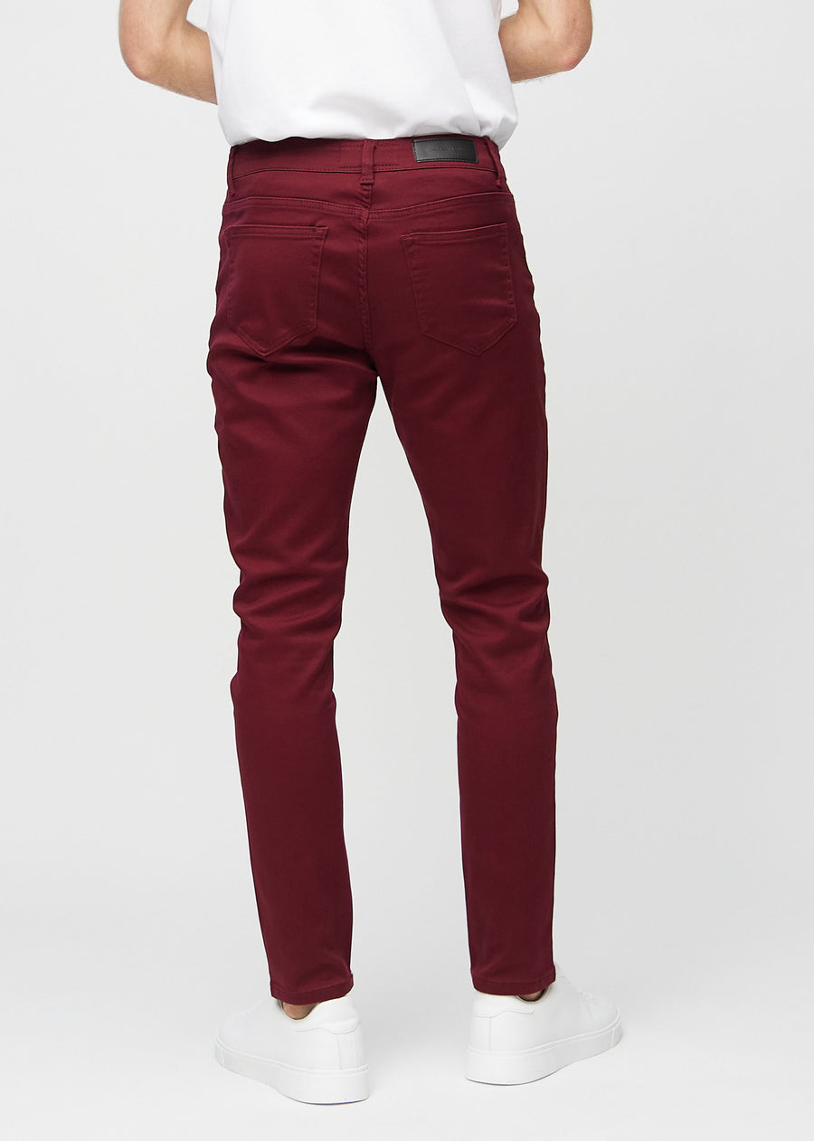 Dark red slim jeans viewed from the back to show the full product.