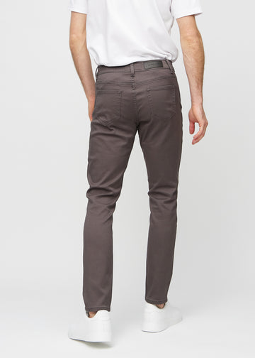 Grey-brown slim jeans viewed from the back to show the full product.