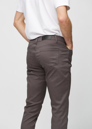 Close-up back view of grey-brown slim jeans showing details.