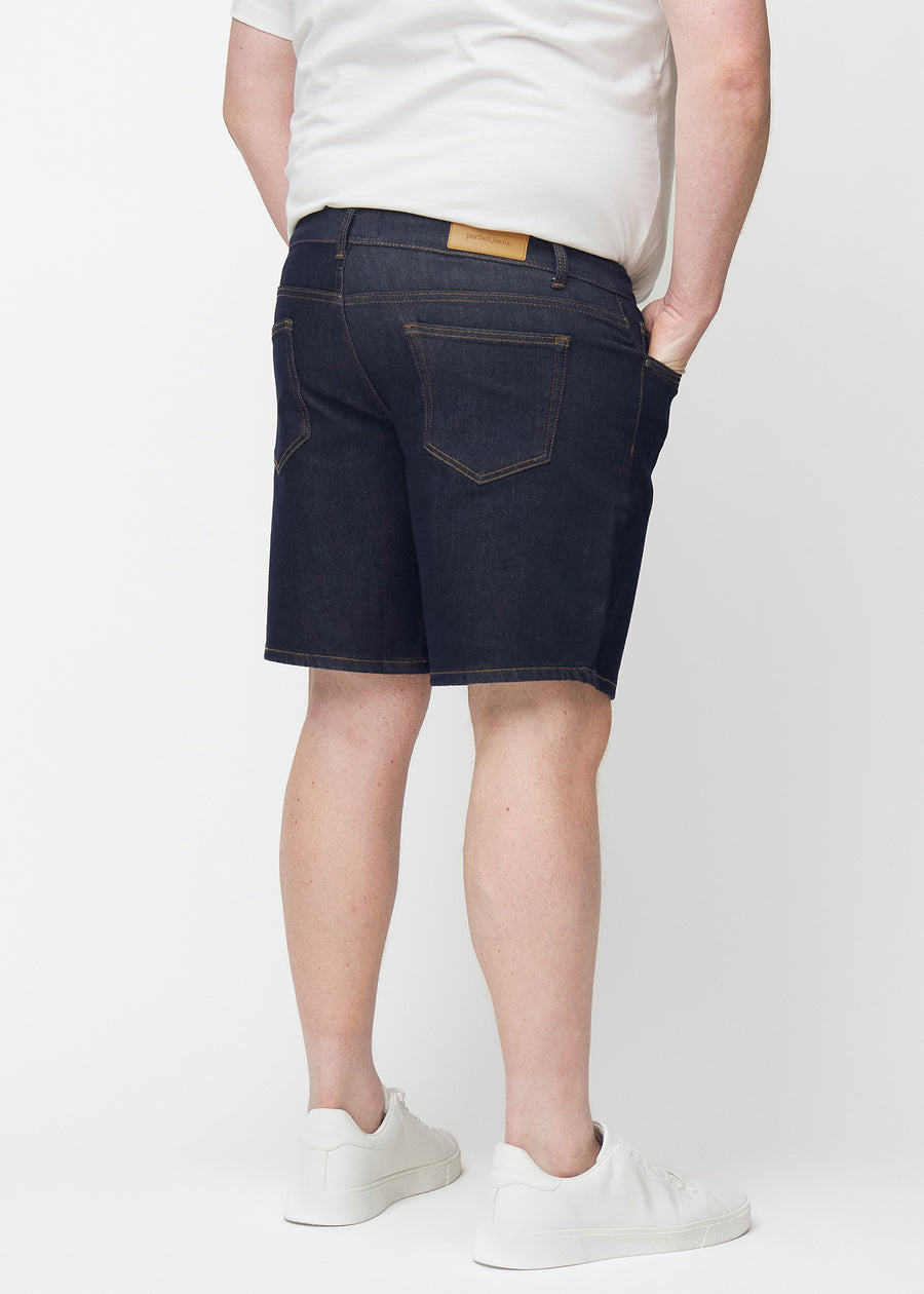 deep dark blue denim shorts for men in the colour midnights seen from the back on a plus-size model.