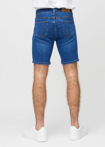 Dark denim middle-slim shorts seen from the back, so the entire product can be seen.