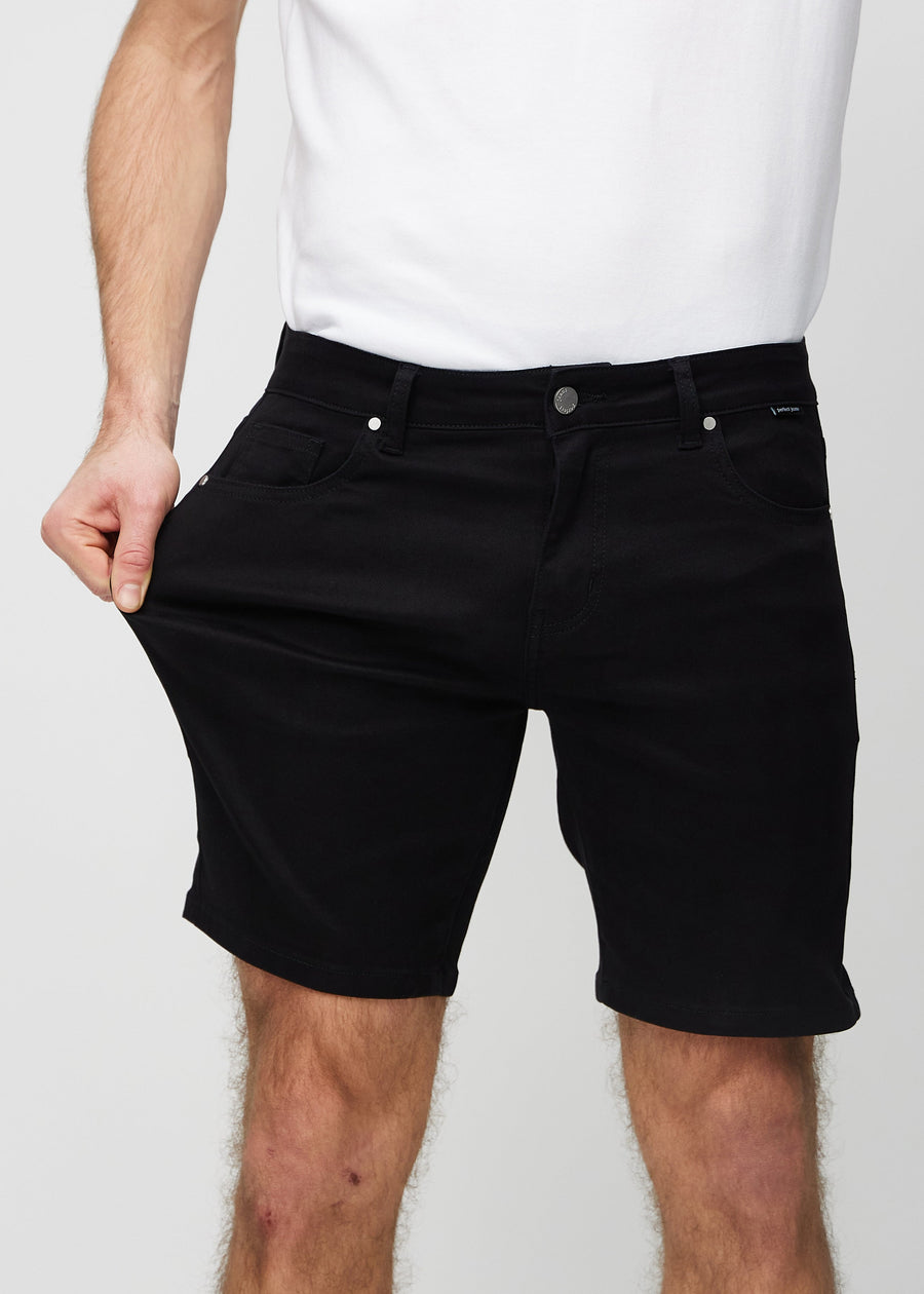 The model stretches the shorts at the thigh to show the stretch.